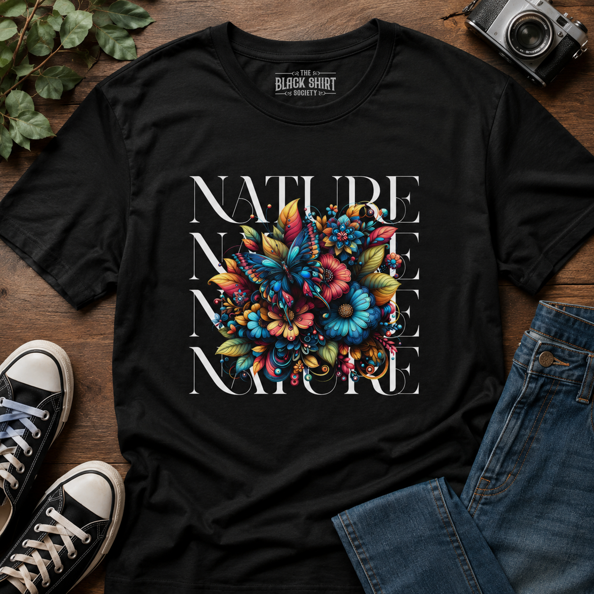 Nature Floral Butterfly Graphic T-Shirt featuring a colorful butterfly surrounded by botanical blooms and elegant typography on a premium cotton tee